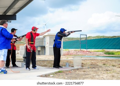 Clay Pigeon Shooting. An Athlete Shoots A Gun At Moving Targets, Sport Gun Shooting, Clay Pigeon Shooting. Training Process At The Shooting Range. Cyprus, Larnaca - August 20, 2022