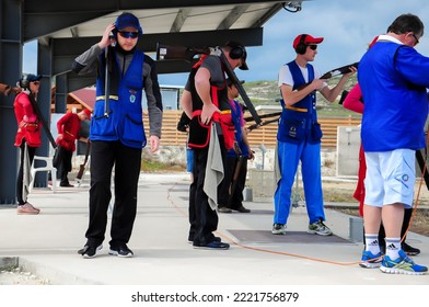 Clay Pigeon Shooting. An Athlete Shoots A Gun At Moving Targets, Sport Gun Shooting, Clay Pigeon Shooting. Training Process At The Shooting Range. Cyprus, Larnaca - August 20, 2022