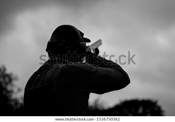 clay pigeon shooting with\
shotgun