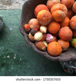 Clay pot filled with fresh fruits and garlic. Organic and natural mood. Orange and dark green background. Bucolic scene that could become a painting. - Shutterstock ID 1750357655