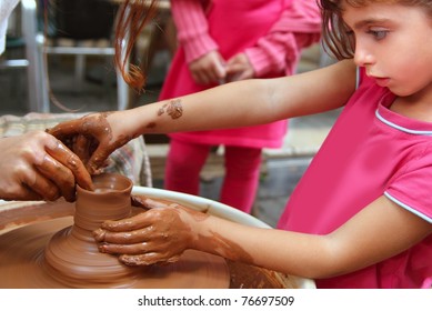 clay potter hands wheel pottery work workshop teacher and girl pupil - Powered by Shutterstock