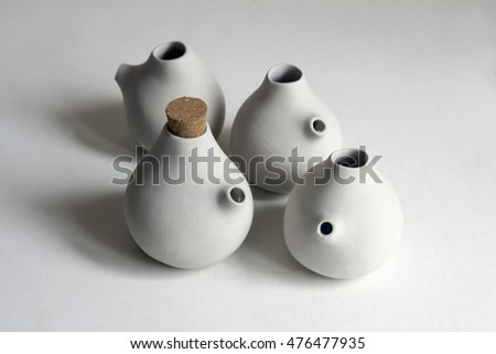 Clay pottery ceramics drying before being fire. Raw clay pots on white background. 