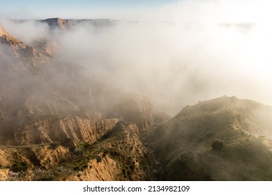 clay ravines, covered in fog, called the barrancas del burujon in Toledo, Spain
