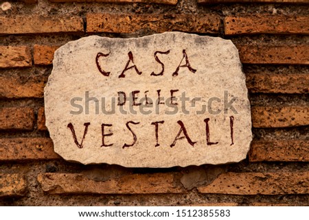 A clay street sign in Rome translated as 'Street of the Vestals' 