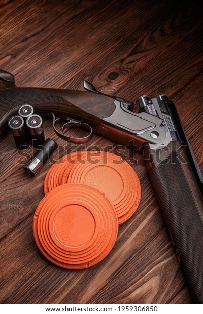 Clay target plates for shooting with rifle on wooden\
background. 