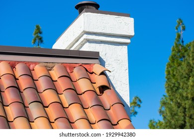 Clay Tile Rooftop With Several Roof Tiles Dislodged By Strong Winds During Storm. The Shifted Tiles Require Repair To Prevent Water Leak And Interior Damage