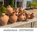 Clay vessels, jugs and vases, on a table, prepared for sale. Paphos area, Cyprus