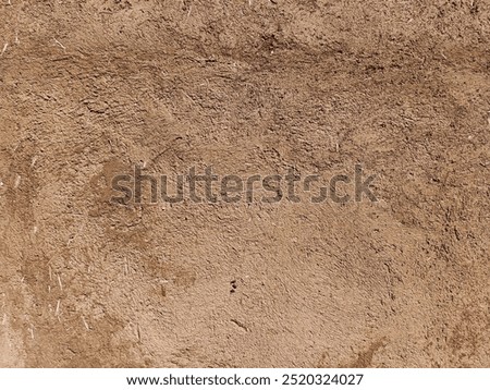 Clay wall of a clay house structure background. Brown clay mud grunge cement texture wall.