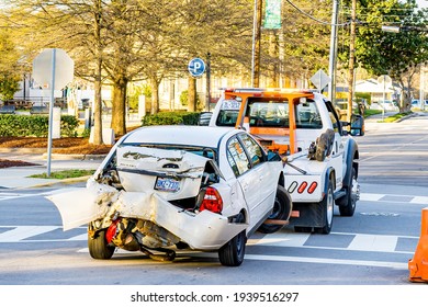 Clayton, North Carolina USA-03 19 2021: A Car Is Towed Away By A Tow Truck After A Serious Rear End Collision.