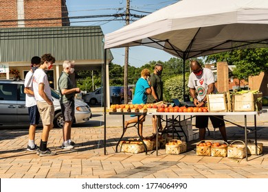 Clayton, North CarolinaUSA-7112020: Photo Depicts the Clayton Farmers Market on a Saturday. A Vendor is Selling Produce.