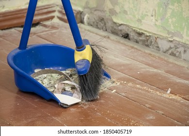 Clean Up After Repairs. Sweep Up Construction Debris With A Brush In A Dustpan. Sweeping At Home. Tools For Cleaning The House. Make Home Repairs. The Dust And Debris After The Renovation.