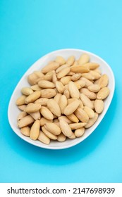 Clean Almonds On Small White Dish On Blue Paper