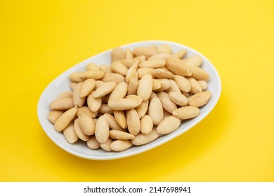 Clean Almonds On Small White Dish On Yellow Paper