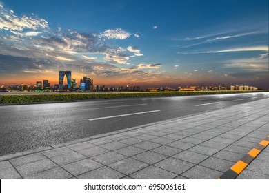 Clean Asphalt Road With City Skyline Background, China.
