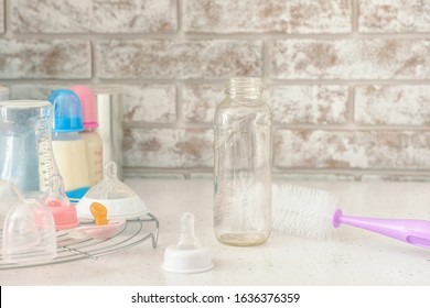 Clean Baby Bottle With Brush On Table