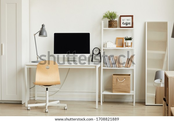 Clean\
background image of minimalistic apartment interior with focus on\
computer desk against white wall, copy\
space