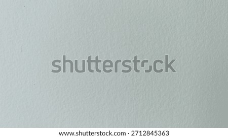 Clean background of the wall is light gray or ivory white with a smooth texture