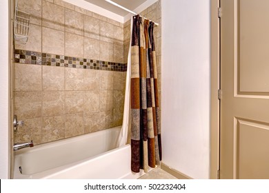 Clean Beige And White Bathroom With Mosaic Tile Wall Trim In The Shower, Colorful Shower Curtain. Northwest, USA