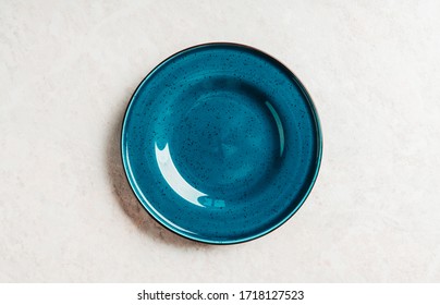 Clean Blue Plate On The Rustic Background. Selective Focus. Shot From Above.
