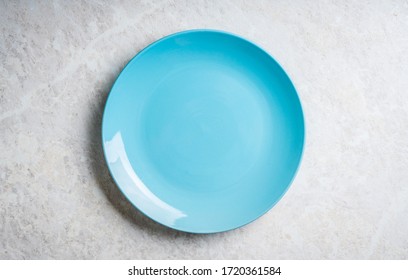 Clean Blue Plate On The Rustic Background. Selective Focus. Shot From Above.