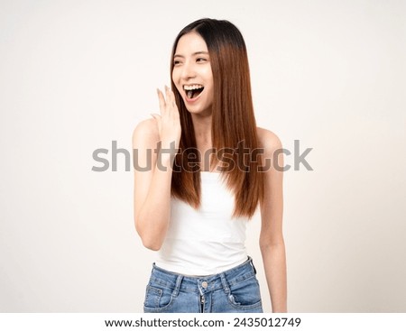 Clean breath fresh breath. A woman with good oral health beautiful teeth clean and no bad breath. She sniffed at her mouth covering it with her hand standing on isolated background