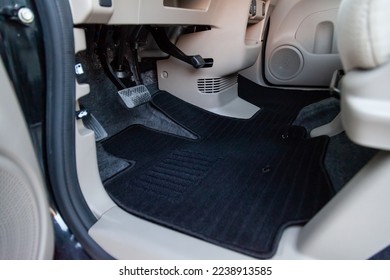 Clean car floor mats of black carpet under front driver seat in the workshop for the detailing vehicle before dry cleaning. Auto service industry. Interior of sedan. - Shutterstock ID 2238913585