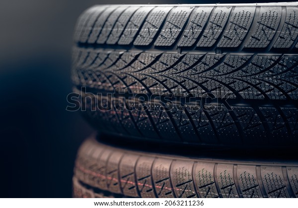 Clean\
car tyres spinning against dark background\
closeup