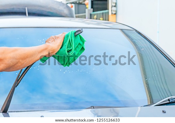 Clean\
car wipers in rainy season for safe driving on\
road