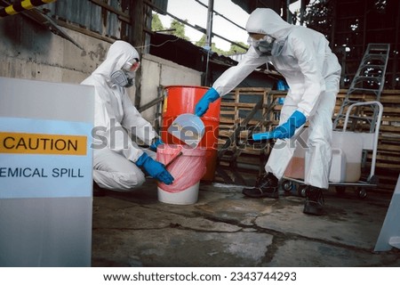 Clean up Chemical Liquid Spill. Scoop Materials into Toxic Waste Red Bag and Thick Plastic Barrels for Disposal, Dispose of Material Safely. Part of Basic Practical Training for Chemical Spill.