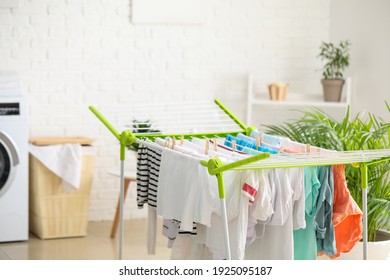 Clean Clothes Hanging On Dryer In Laundry Room