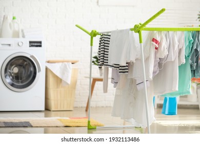 Clean Clothes Hanging On Dryer In Laundry Room