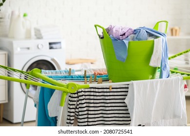 Clean clothes hanging on dryer in laundry room