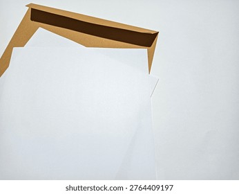 Clean composition of blank papers and an envelope symbolizing legal documents, business communication, paperwork, and administrative processes.