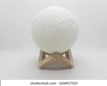 Clean Desktop Moon Spherical Shape Electric Lamp For Bed Side Home Interior Lighting In White Isolated Background