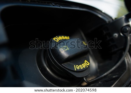 Clean Diesel Car Tank Cup Closeup. Diesel Fueling Concept Photo.