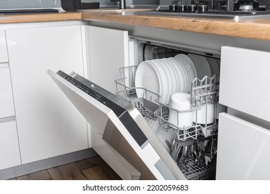 Clean dish and cutlery on dishwashing machine - Shutterstock ID 2202059683