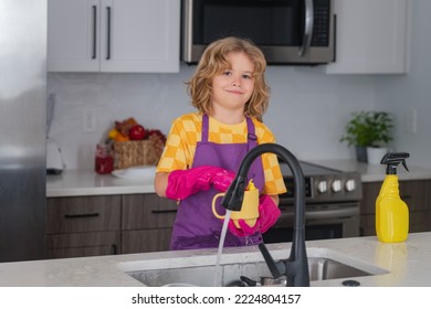 Clean Dishes. Child Doing And Wiping Dishes In Kitchen. Little Kid Cleaning At Home. Child Doing Housework Having Fun. Cute Child Boy Helping With Housekeeping In Kitchen, Cleaning.