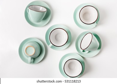 Clean Dishes, Coffee Or Tea Set. Plenty Of Elegant Porcelain Light Blue Cups And Saucers At White Background, High Key, Top View And Flat Lay.