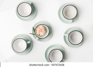 Clean Dishes, Coffee Or Tea Set. Plenty Of Elegant Porcelain Cups And Saucers With Flower Inside At White Background, High Key, Top View And Flat Lay.