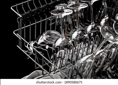 Clean Dishes In The Dishwasher. Wine Glasses, Sparkling Wine Glasses. Close-up. Washing-up And Housework Concept