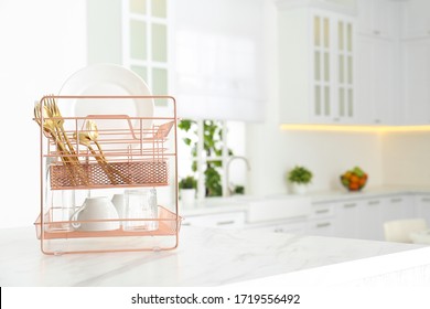 Clean Dishes On Drying Rack In Modern Kitchen Interior, Space For Text