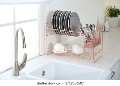 Clean Dishes On Drying Rack In Modern Kitchen Interior