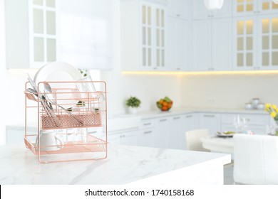 Clean Dishes On Drying Rack In Modern Kitchen Interior, Space For Text