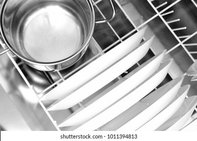 Clean Dishes And A Steel Pot In The Dishwasher Basket, From Above, Close Up