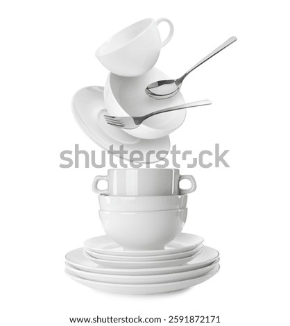 Clean dishware and silverware flying over tableware on white background