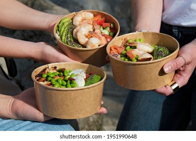 Clean Eating Diet Concept. Three Women Holding Takeout Bowls For Different Dieting Habits. Disposable Paper Containers With Healthy Food. Close Up, Copy Space, Top View, Background.