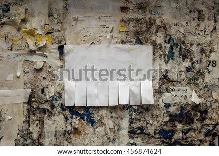 Clean empty paper ads pasted on street bulletin board. Background template to add text