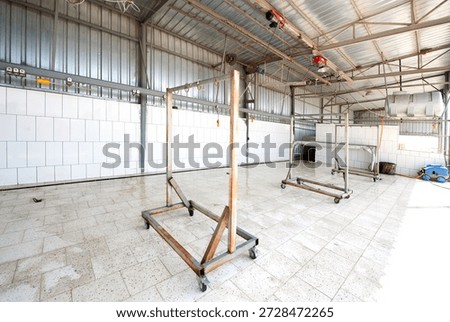 Clean and empty slaughterhouse interior in Turkey, prepared for livestock processing during Eid al-Adha and Kurban Bayramı, showing hygienic conditions, industrial structure and religious tradition.