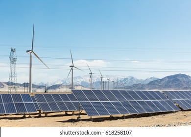 Clean Energy On Snow Area Plateau, Solar Panels And Wind Power Farm In Golmud, China