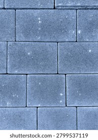 Clean flat lay texture of grey concrete paving stones in a patte